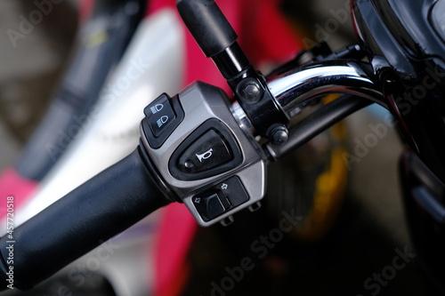 The handlebar switch on the left side of the motorcycle.