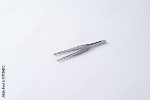 metal tweezers on a white background