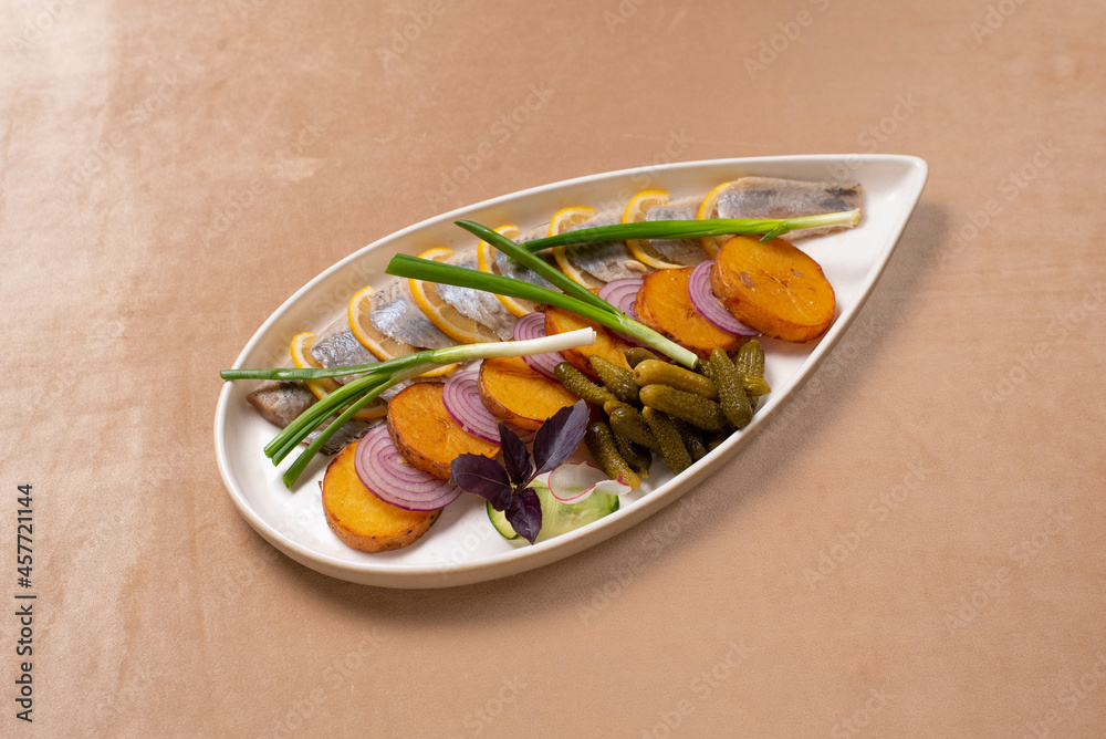 snack. herring with lemon, fried potatoes, onions and pickles snack. herring with lemon, fried potatoes, onions and pickles