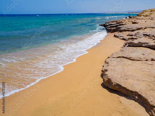 Beautiful wild beach with turquoise water, orange sand and coral reef. Egypt, Marsa alam. Red sea