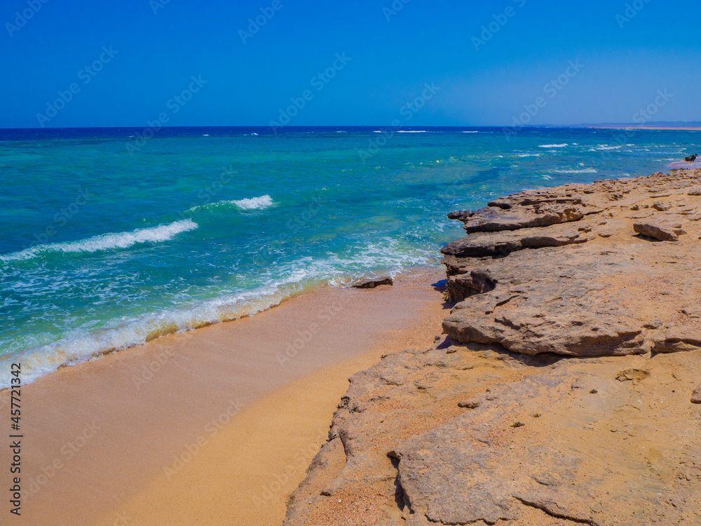 Beautiful wild beach with turquoise water, orange sand and coral reef. Egypt, Marsa alam. Red sea