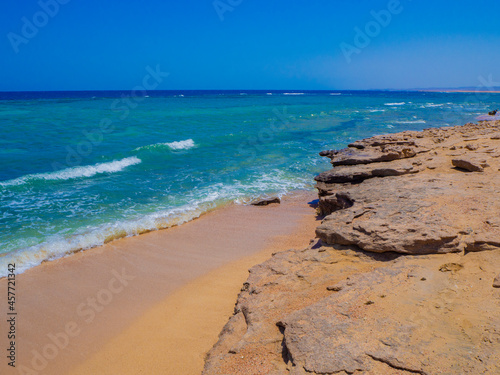 Beautiful wild beach with turquoise water  orange sand and coral reef. Egypt  Marsa alam. Red sea
