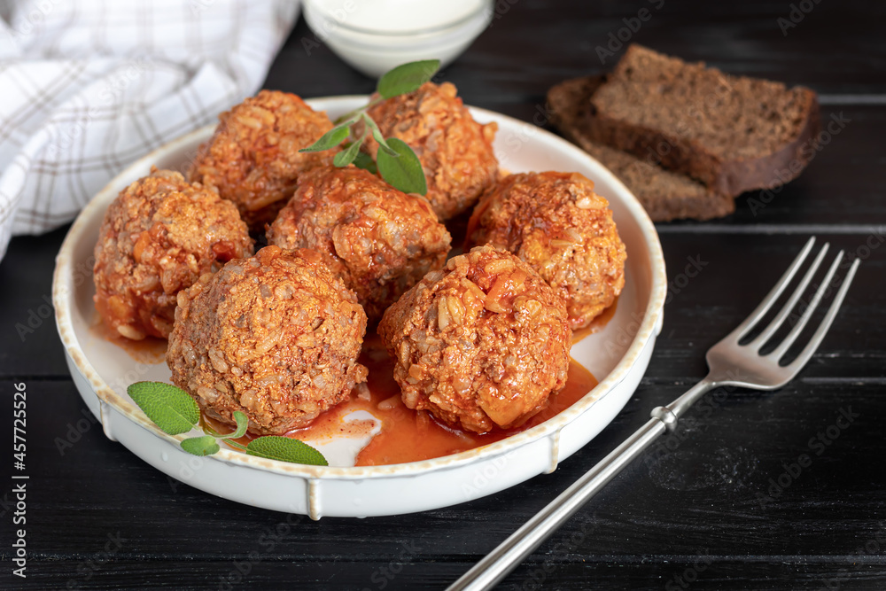Meat balls on a wooden background with sage and parsley leaves. Homemade lunch. Meat balls on a wooden background with sage and parsley leaves. Homemade lunch.