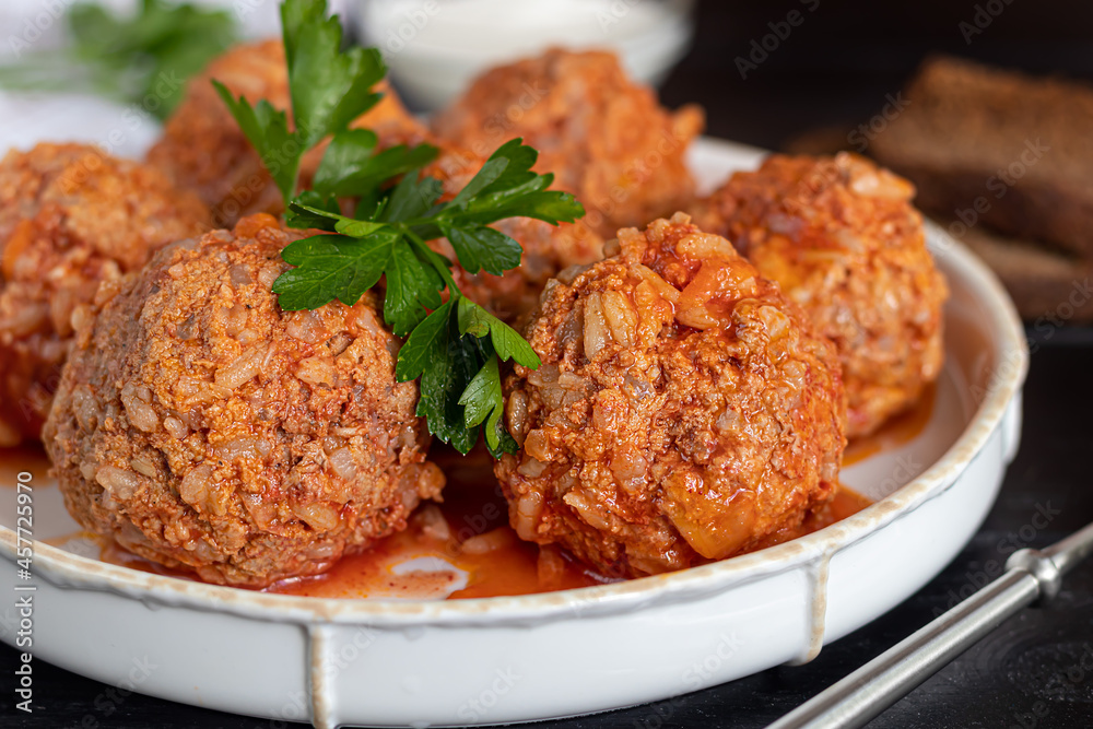 Meat balls on a wooden background with sage and parsley leaves. Homemade lunch. Meat balls on a wooden background with sage and parsley leaves. Homemade lunch.