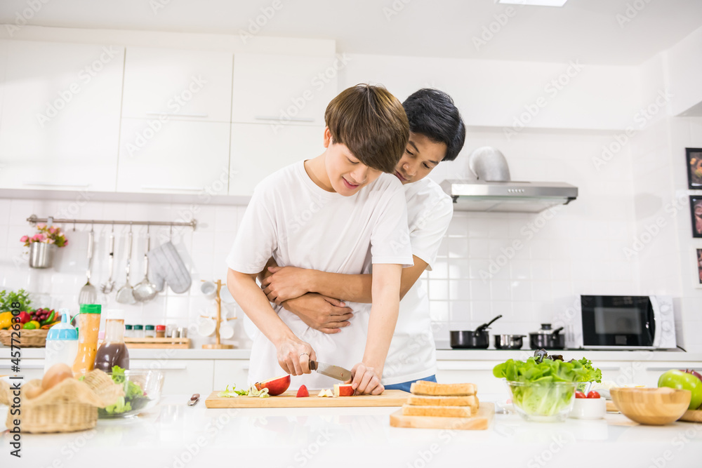 Sweet lgbt asian couple cook at home kitchen Sweet lgbt asian couple cook at home kitchen