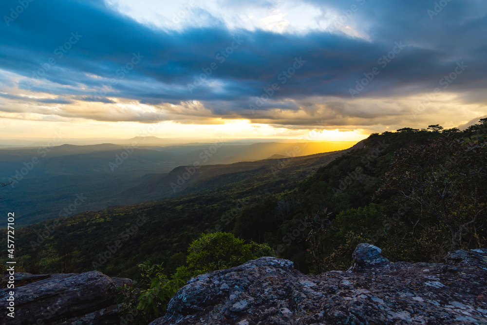 The  mountain ridges with sun light, sunset sky and the blurred rock forground.  Location place Phu Kra Dueng National park of Thailand