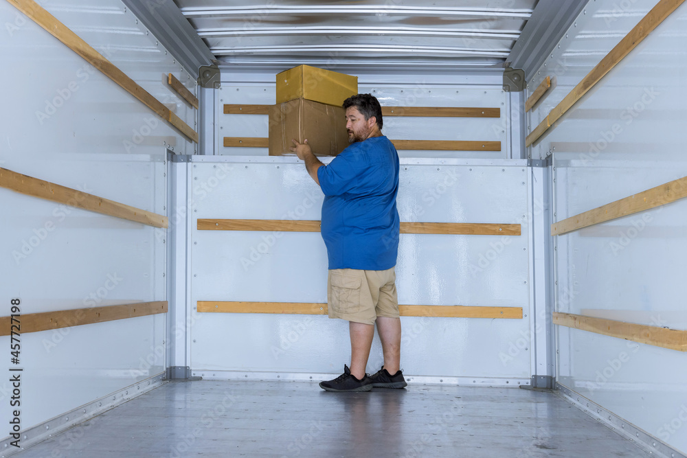 Delivery boxes man holding in boxes with moving car Delivery boxes man holding in boxes with moving car