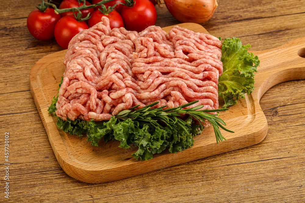 Raw pork minced meat over board Raw pork minced meat over board