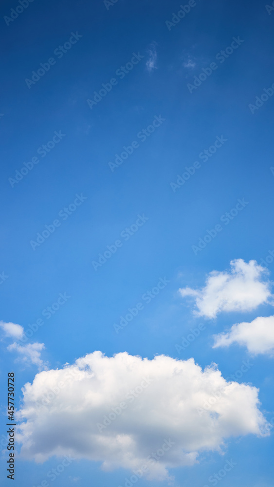 Fototapeta premium Cloud single lonely in high empty sky with beams vertical composition 16x9 with copyspace.