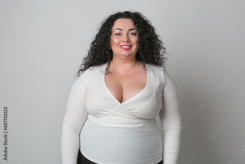 Overweight young woman with big breast wearing white shirt with deep ...