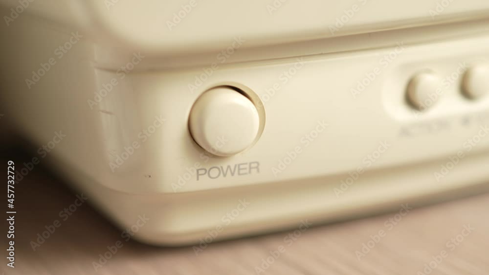 Pressing The Power Button on a White Device Closeup