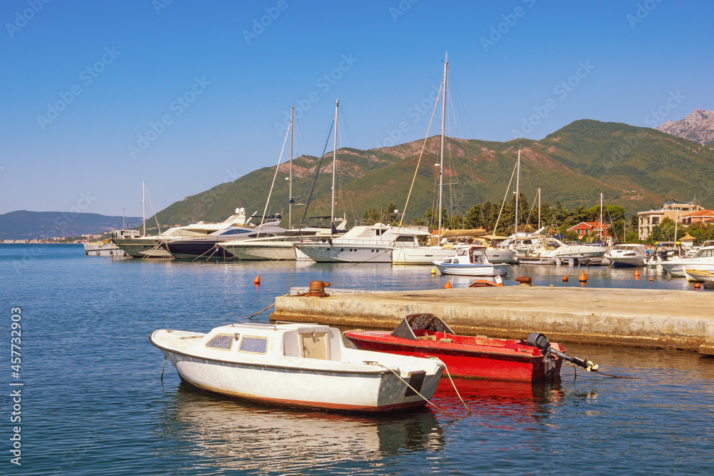 Beautiful Mediterranean landscape. Sailboats and fishing boats on water. Montenegro, Adriatic Sea.  Kotor Bay near Tivat city on sunny autumn day