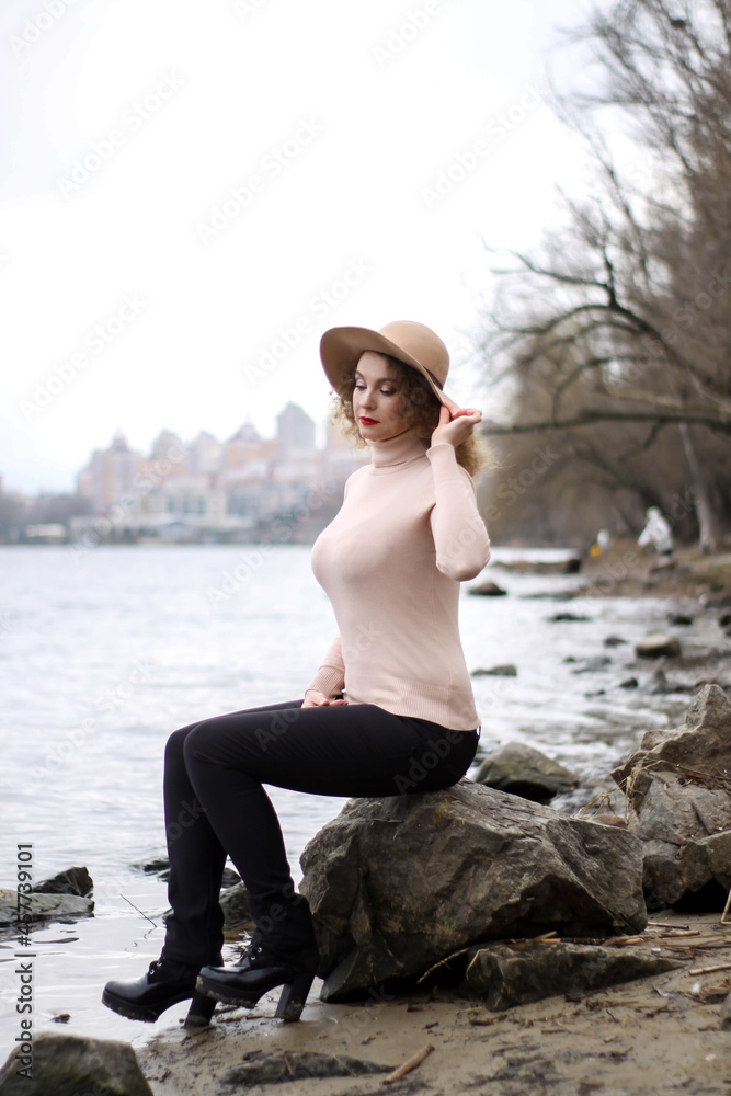 beautifful curly girl with a hat in pastel colors