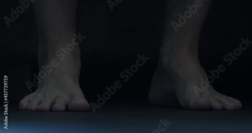 Slow motion man put his feet on floor in midnight photo