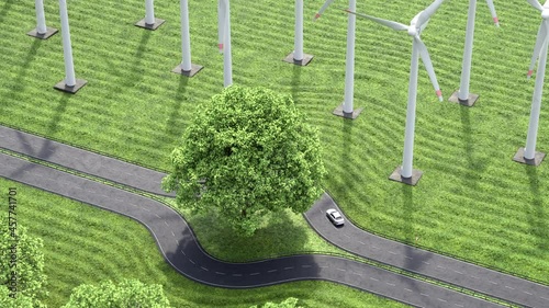 Green infrastructure surrounding a tree. Road surrounded by fields and wind turbines.