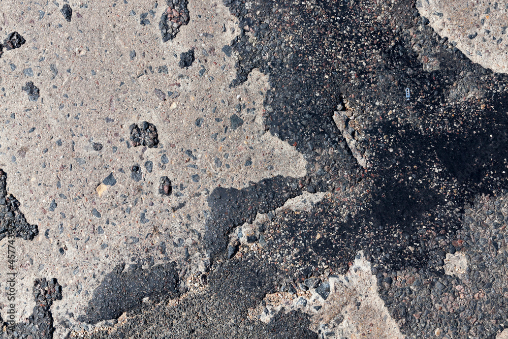 a bad asphalt road that has been repaired many times a bad asphalt road that has been repaired many times