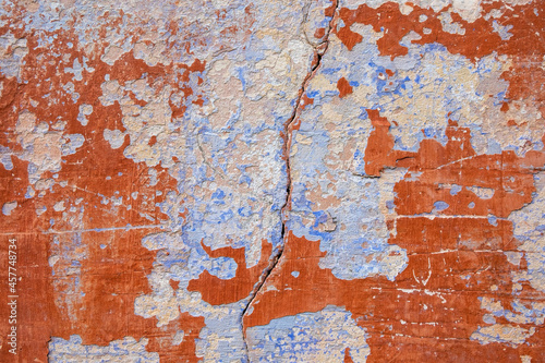 Background image of the plaster texture in red and orange tones with a blue light area and a crack.