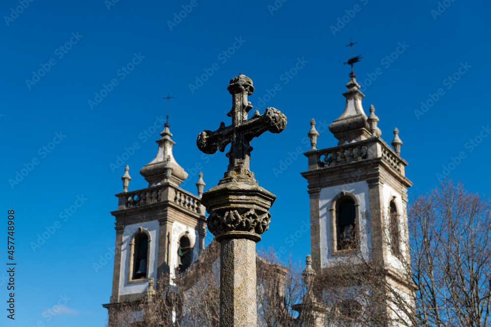 Detail of of an old stone cross in front of a church, in the city of Guarda, Portugal