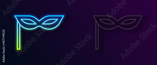 Glowing neon line Carnival mask icon isolated on black background. Masquerade party mask. Vector