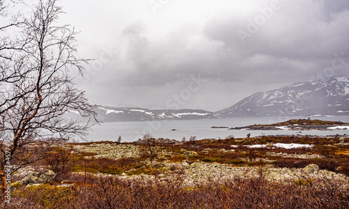 Vavatn lake panorama rough landscape snowed-in mountains Hemsedal Norway. photo