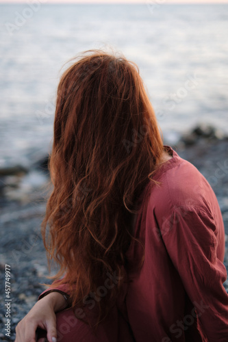 Redhead girl on the shore