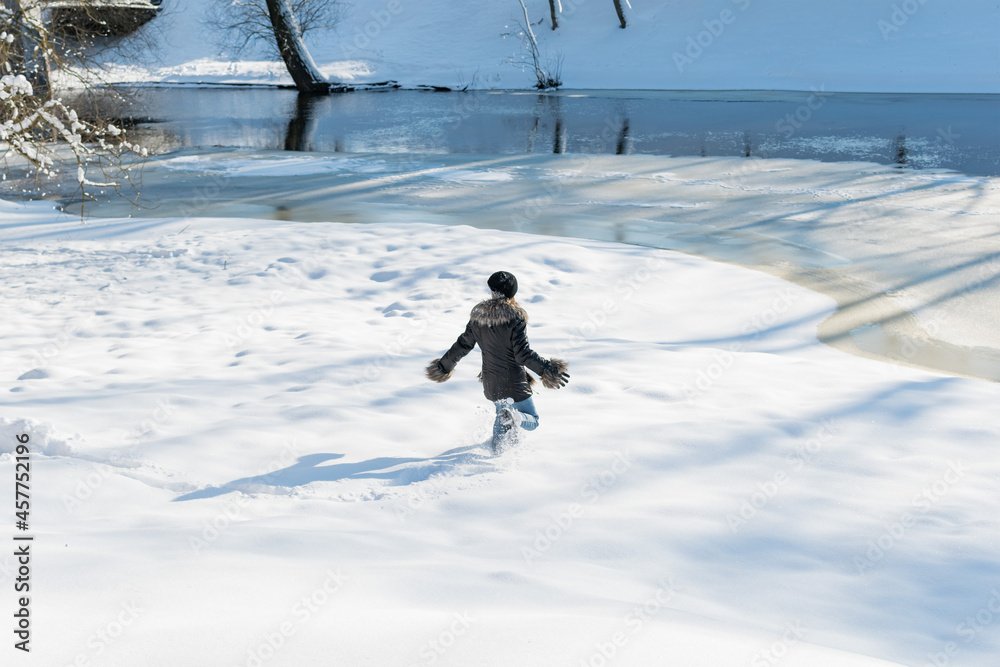 Young girl playing in the snow