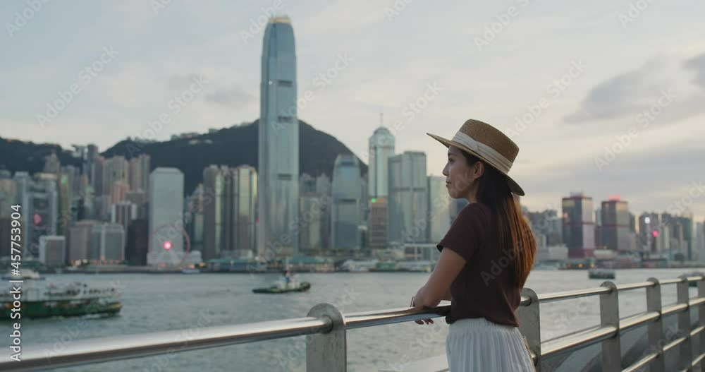 Woman enjoy night view in Hong Kong city Woman enjoy night view in Hong Kong city