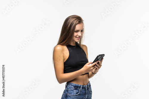 Beauty young woman using and reading a smart phone isolated on a white background