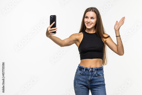 Beautiful young woman making video call with smartphone isolated on a white background
