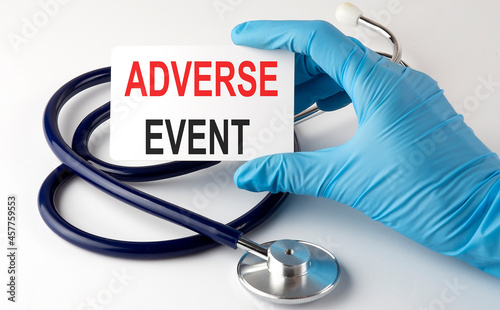 Card with text ADVERSE EVENT , pills and stethoscope. Medical concept.
