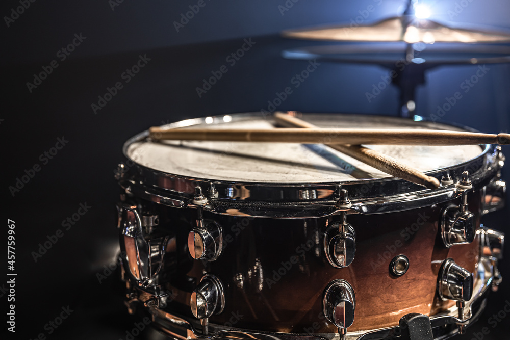Obraz premium Part of a drum kit, snare drum on a dark background.