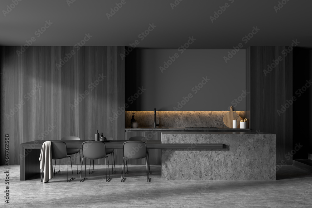 Fototapeta premium Dark grey kitchen space with stylish dining table