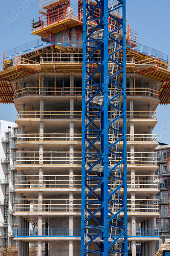 Highrise under construction with a crane in the foreground