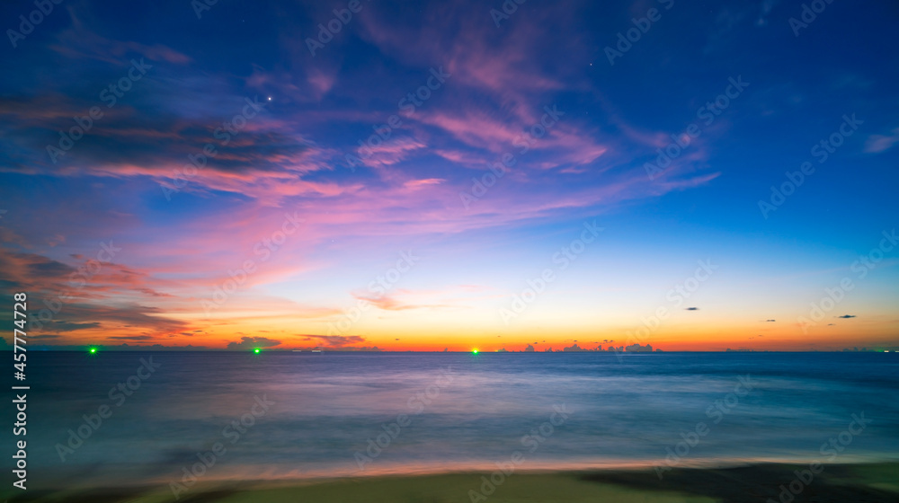 Amazing seascape with sunset clouds over the sea with dramatic sky sunset or sunrise Beautiful nature minimalist background and texture Panoramic nature view landscape.