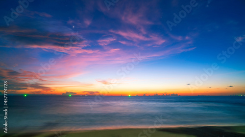 Amazing seascape with sunset clouds over the sea with dramatic sky sunset or sunrise Beautiful nature minimalist background and texture Panoramic nature view landscape. © panya99