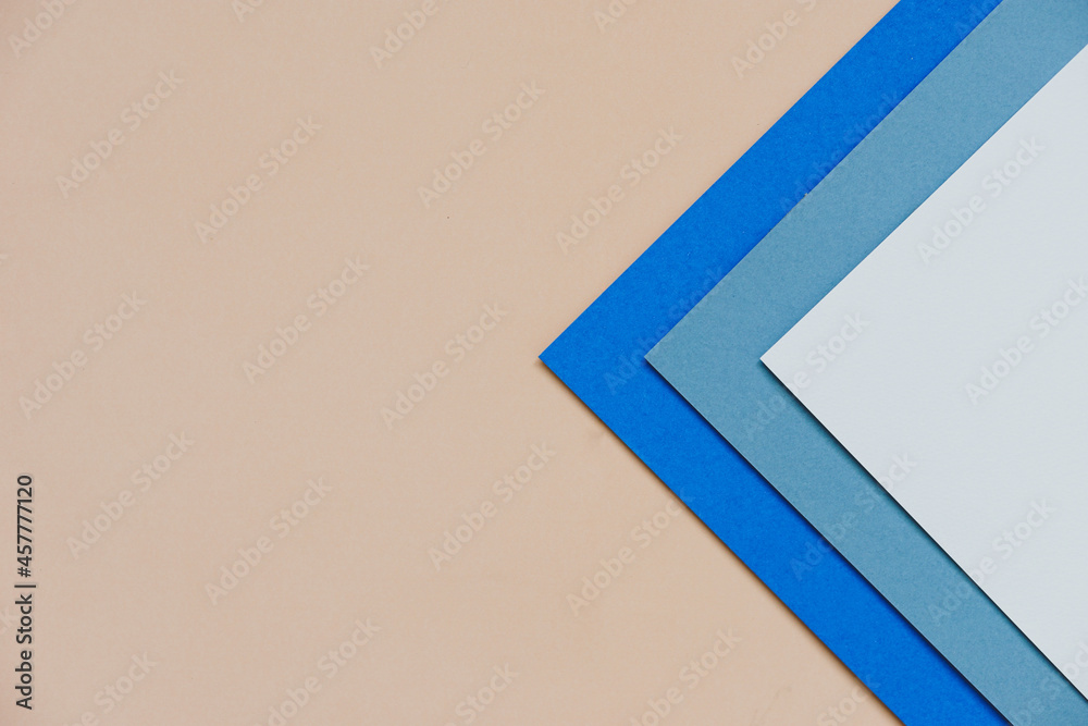 abstract background concept with stacking of color paper in geometric pattern, layers of blank Cobalt blue paper and white paper on brown background. abstract background concept with stacking of color paper in geometric pattern, layers of blank Cobalt blue paper and white paper on brown background.