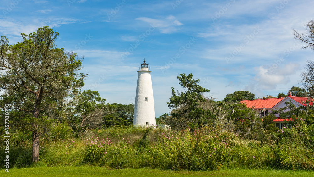 Ocracoke Light and the red roof of the lighthouse keeper's house on a summer morning