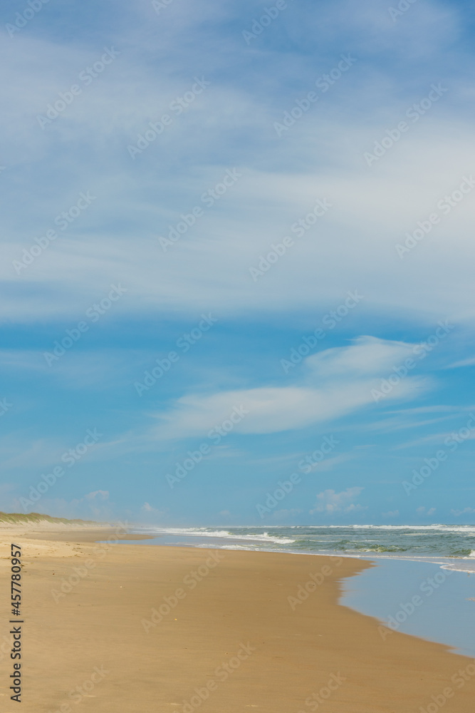 sand beach and blue sky. vertical orientation. copy space. sand beach and blue sky. vertical orientation. copy space.