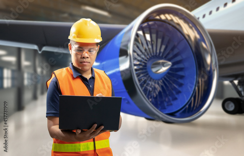 Asian engineer or technician with airplane