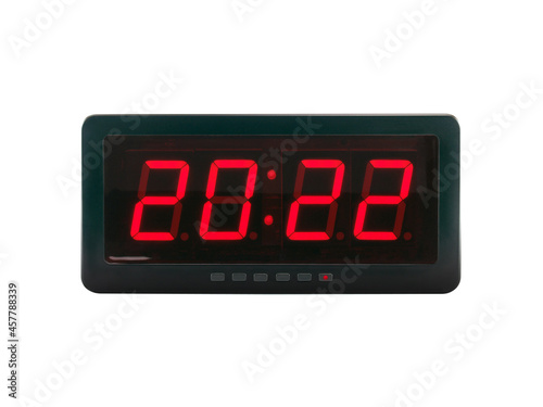 red led light numbers 2022 illuminated on black digital electric alarm clock display isolated on white background, led sign showing time symbol concept for new year countdown