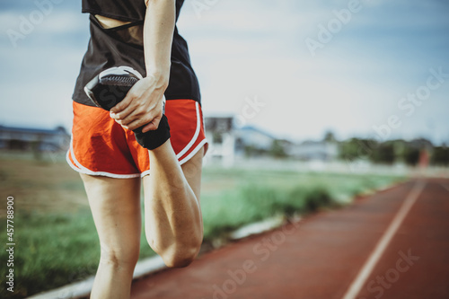 A beautiful woman stretching her body before running in the morning with a bright smile on her face. women's health care concept