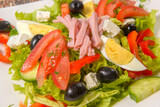 Fresh bulgarian salad with vegetables, tomatoes, onion, olives, boiled eggs, cheese and bacon. Salata bulgareasca traditionala