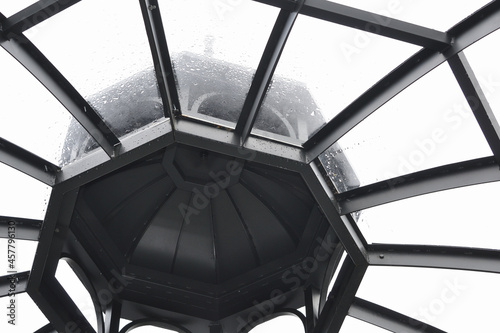 A look upward at the inside of the transparent dome of the rotunda in the rain