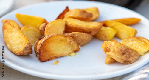 Fried potatoes in a plate on a table