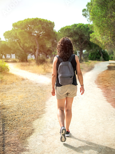 Woman choosing a path in a forest. Concept of decision making in life.