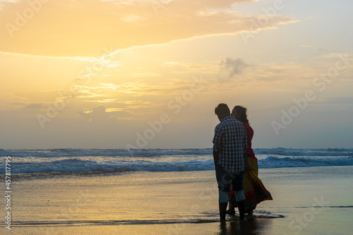 silhouette of a couple walking on the beach, Baga Beach, Goa, India