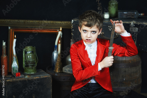 A boy in a vampire costume for Halloween. Studio photo .