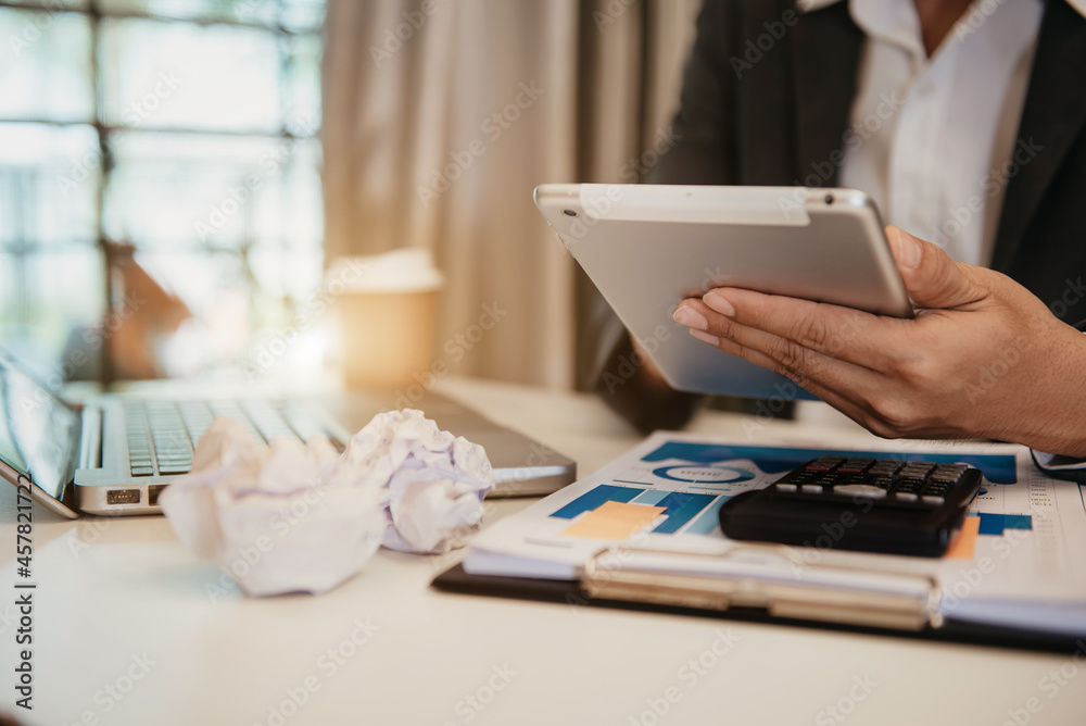 Fototapeta premium Business documents on office table with laptop and digital tablet and calculator on graph financial.