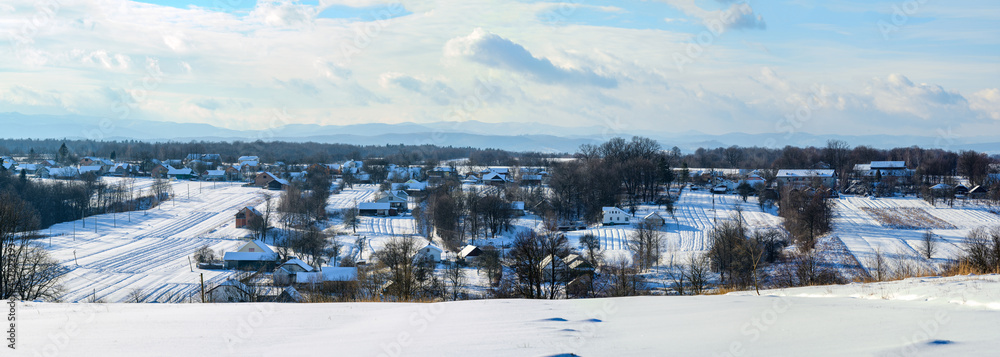 Ukrainian snow-covered villages, panorama of winter and evening villages.