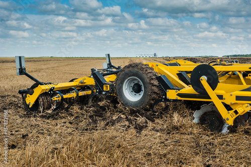 cultivator at work, close up of a disc harrow on a field background